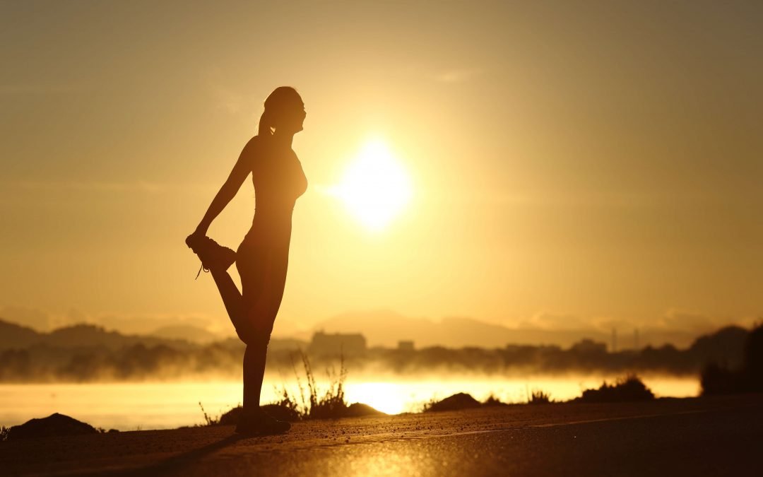 Morning stretch at sunrise by the water